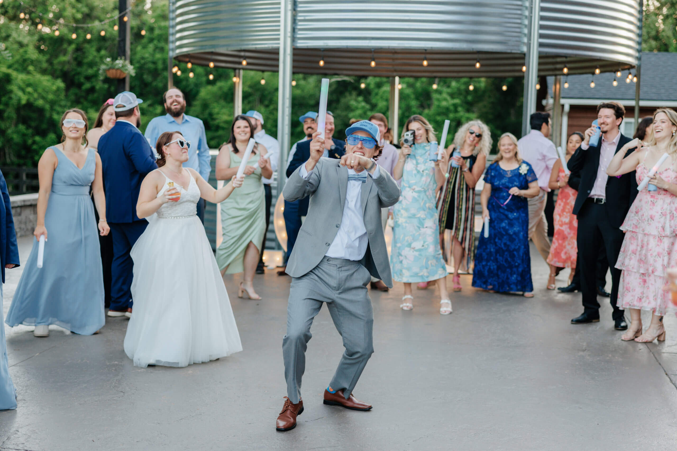 Malden Hill Spring Wedding Photography 42 groomsmen dancing while guests cheer for him all around him