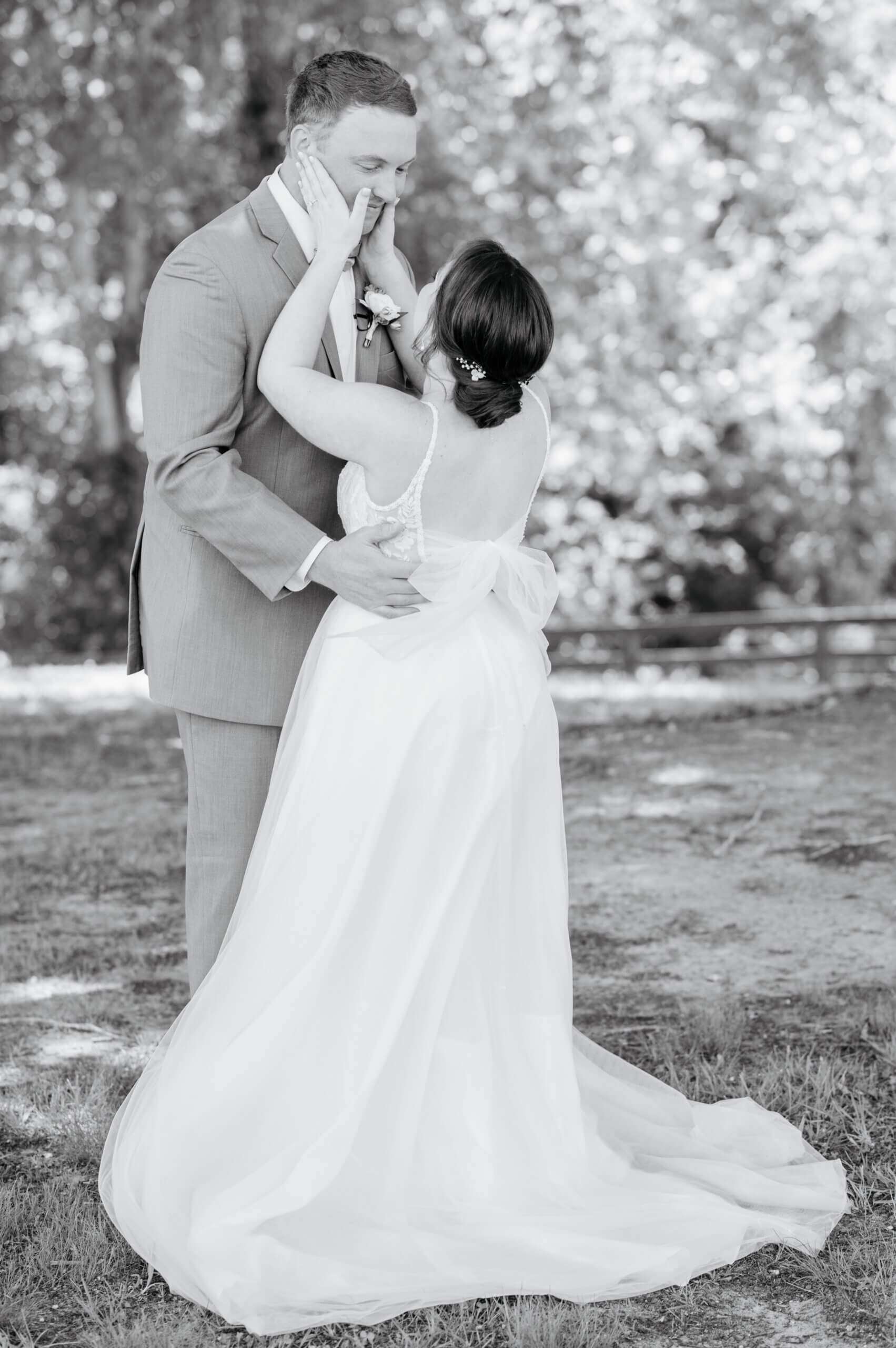 Malden Hill Spring Wedding Photography 6 black and white photo of bride holding groom's face and smiling at him