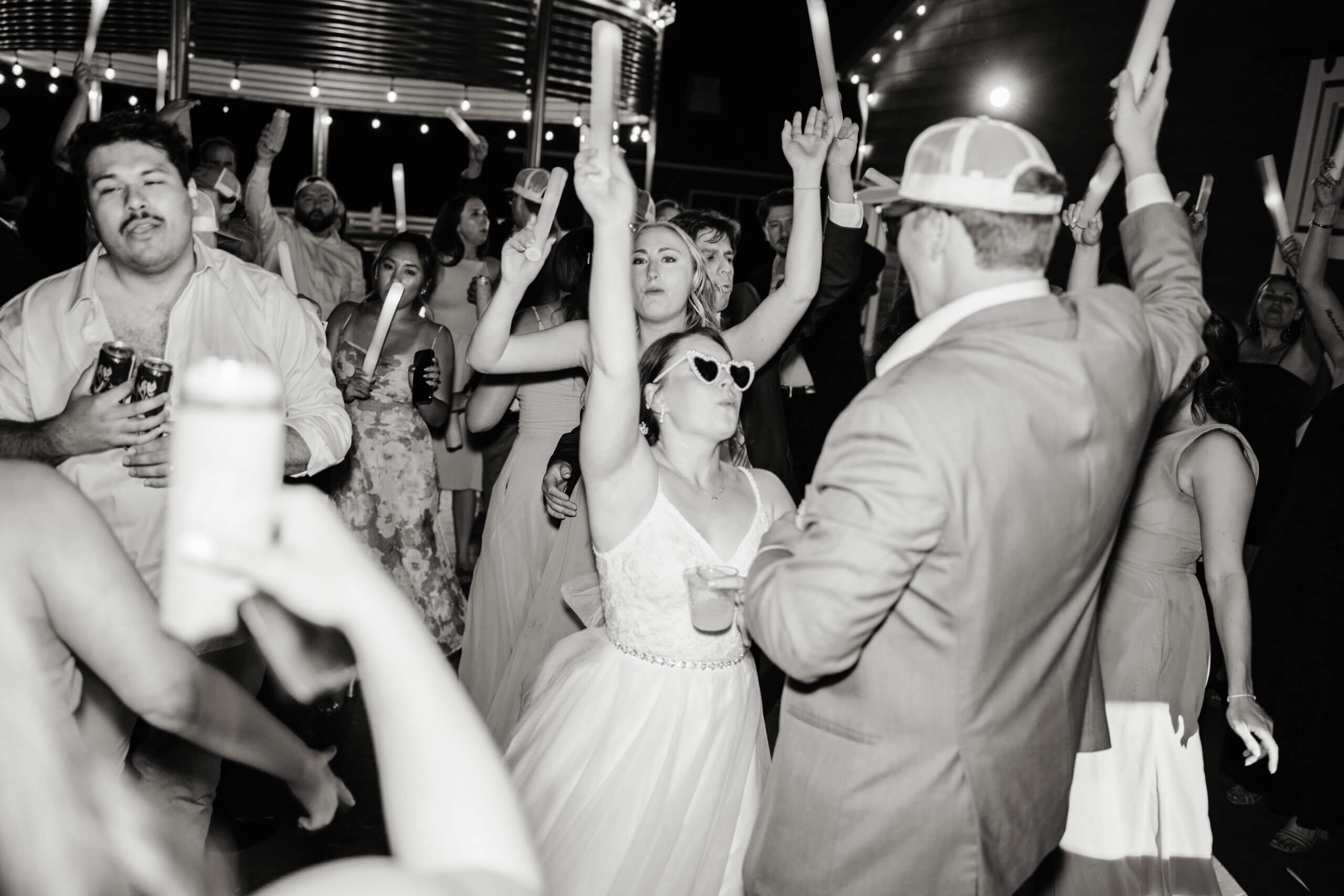 Malden Hill Spring Wedding Photography 45 black and white photo of bride and groom jumping and dancing with their guests