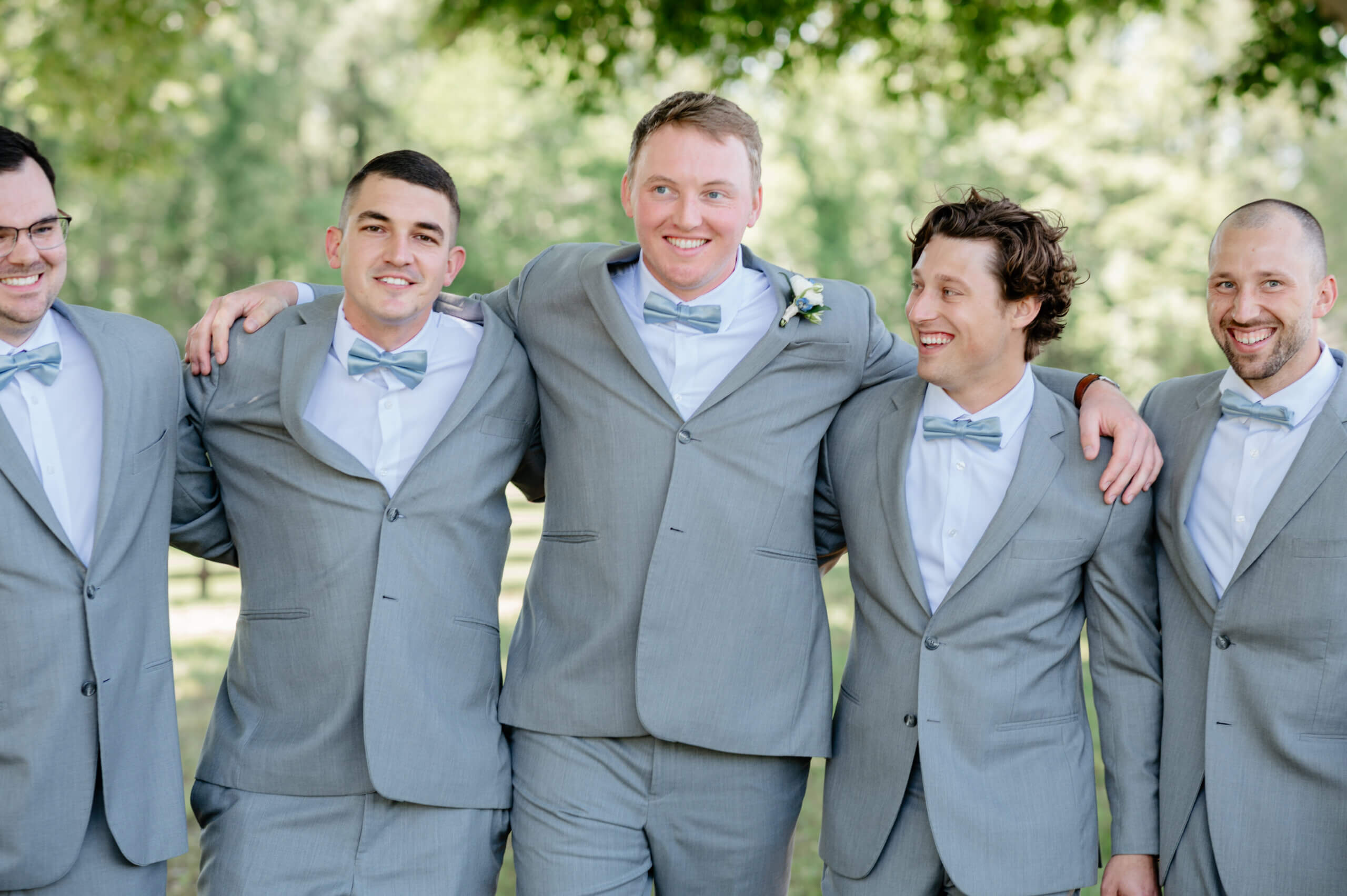Malden Hill Spring Wedding Photography 10 groom and groomsmen standing with arms wrapped around each others's shoulders and smiling