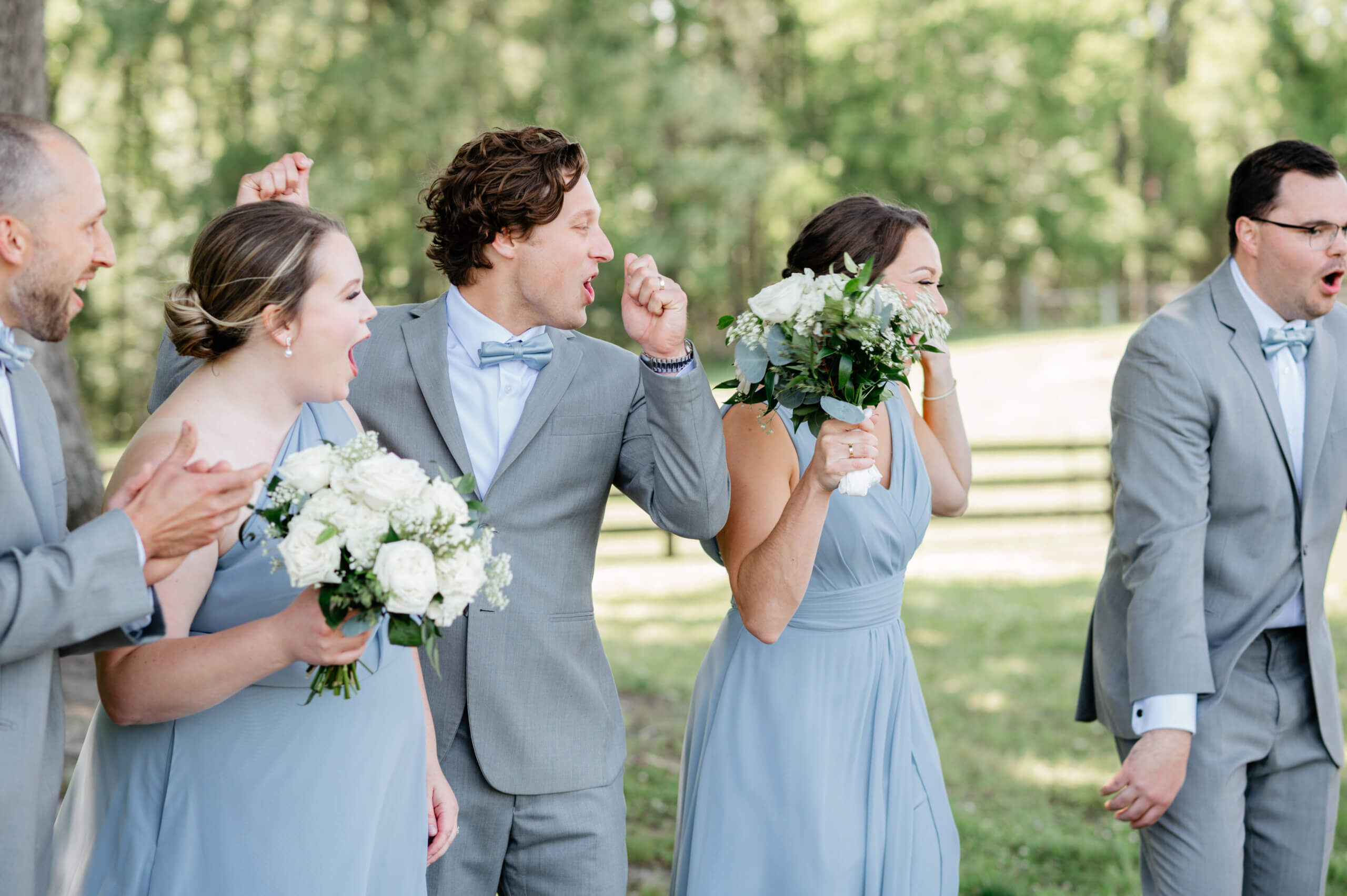 Malden Hill Spring Wedding Photography 11 wedding party wearing grey and light blue cheering and laughing