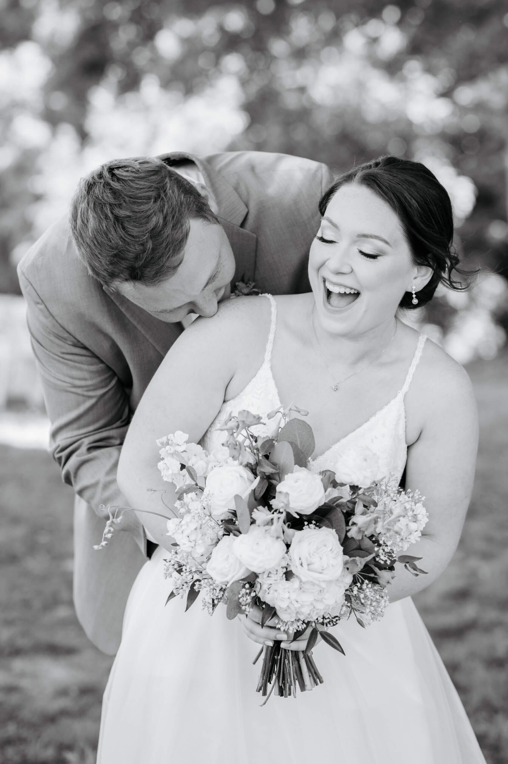 Malden Hill Spring Wedding Photography 15 black and white photo of groom kissing brides shoulder