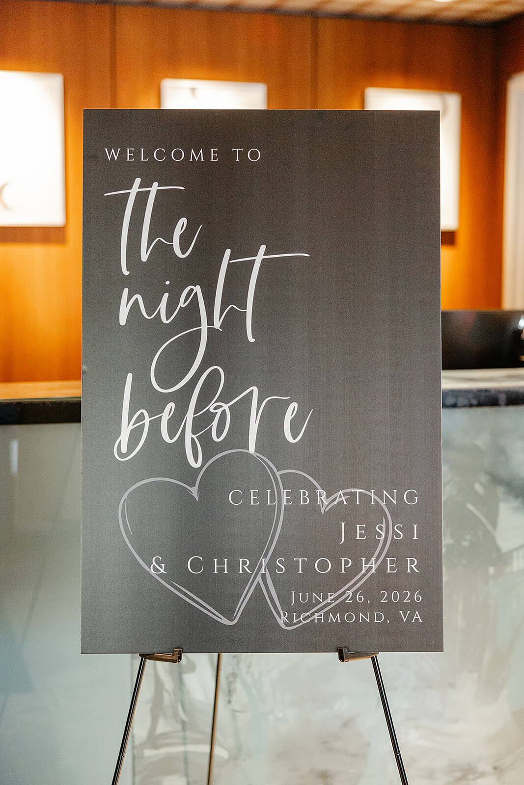 Estate at River Run Summer Wedding Photography 1 black and white sign for rehearsal dinner with wedding details and hearts on it