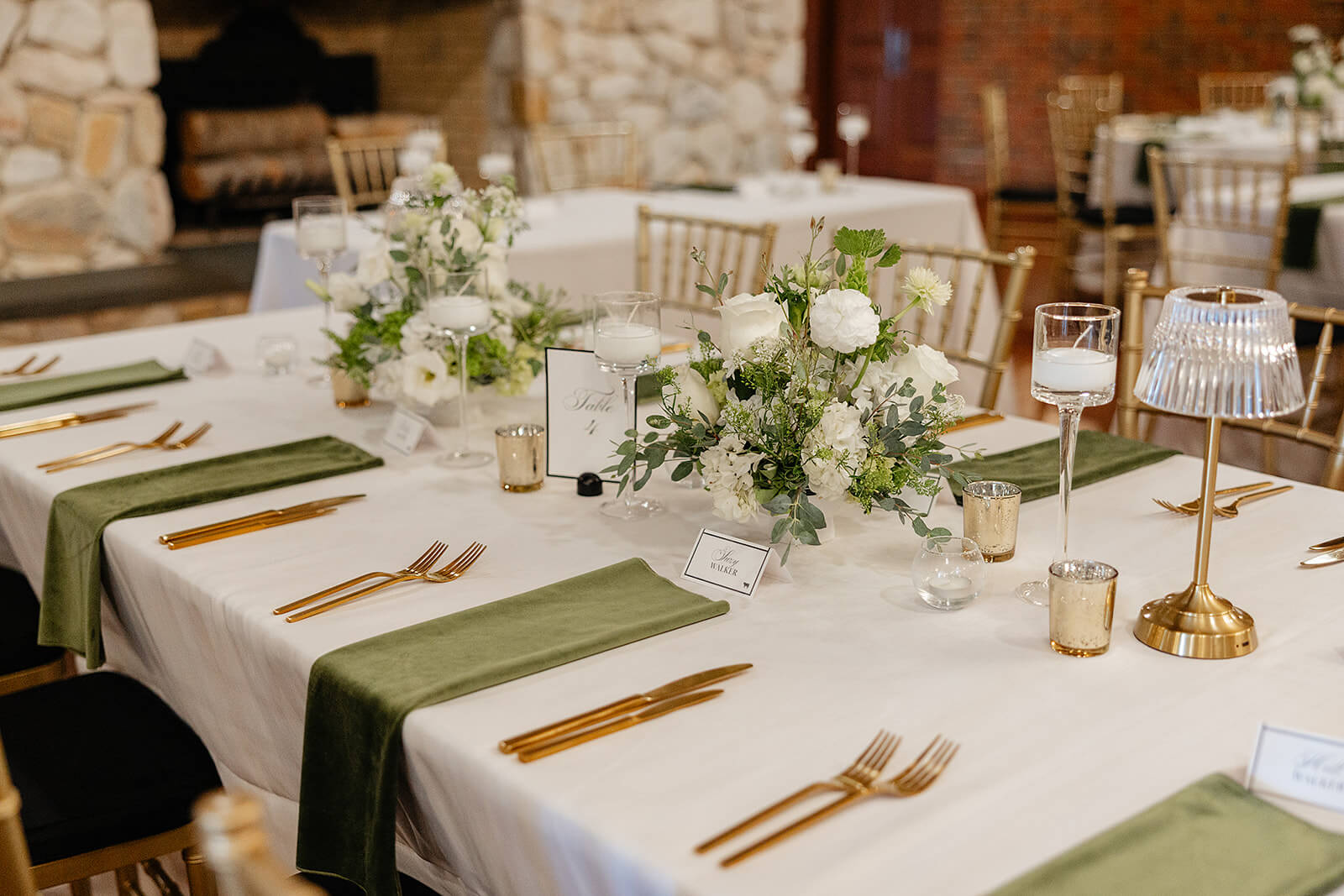 Estate at River Run Summer Wedding Photography 15 detail photo of reception table setting with green and gold lamps, napkins, and utensils