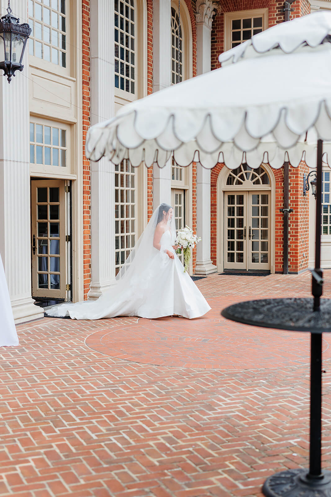 Estate at River Run Summer Wedding Photography 16 bride exiting the building to walk to the aisle which is a brick pathway