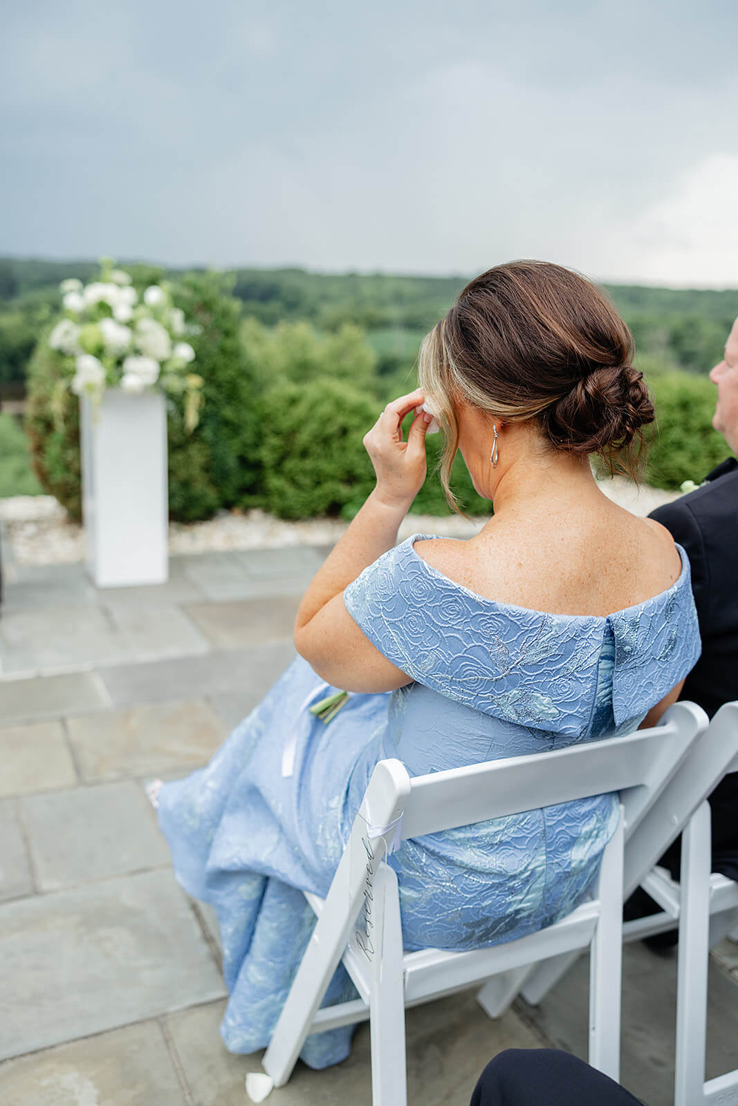 Estate at River Run Summer Wedding Photography 17 shot of behind the mother of the bride. she is wiping tears away