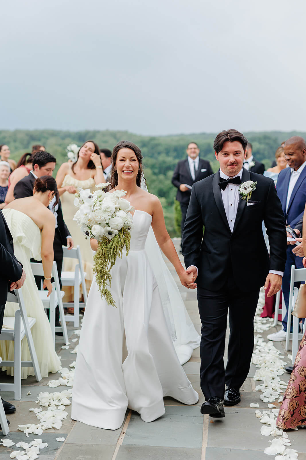 Estate at River Run Summer Wedding Photography 18 bride and groom holding hands as they walk up the aisle