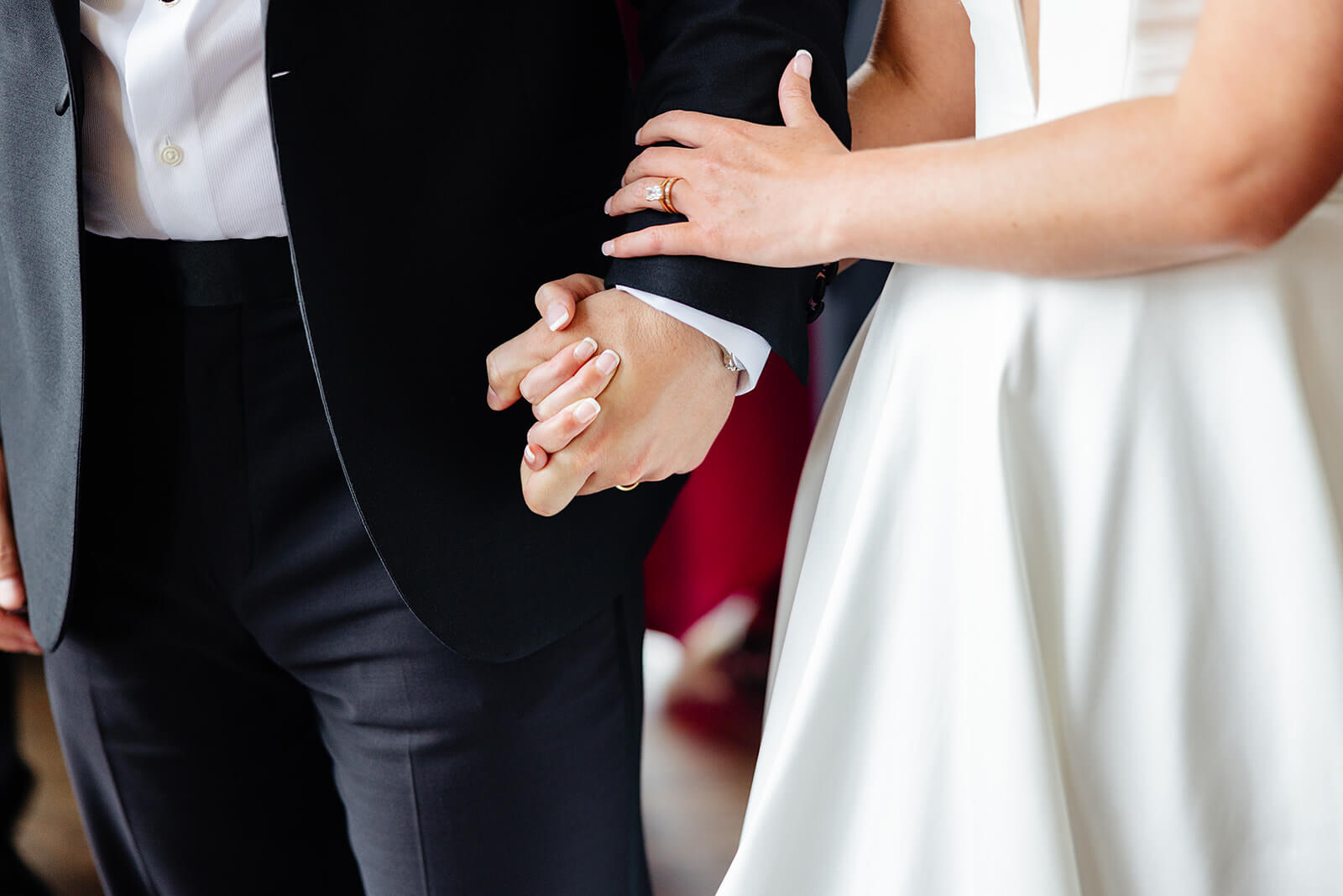 Estate at River Run Summer Wedding Photography 31 detail photo of bride and groom holding hands with their wedding rings on