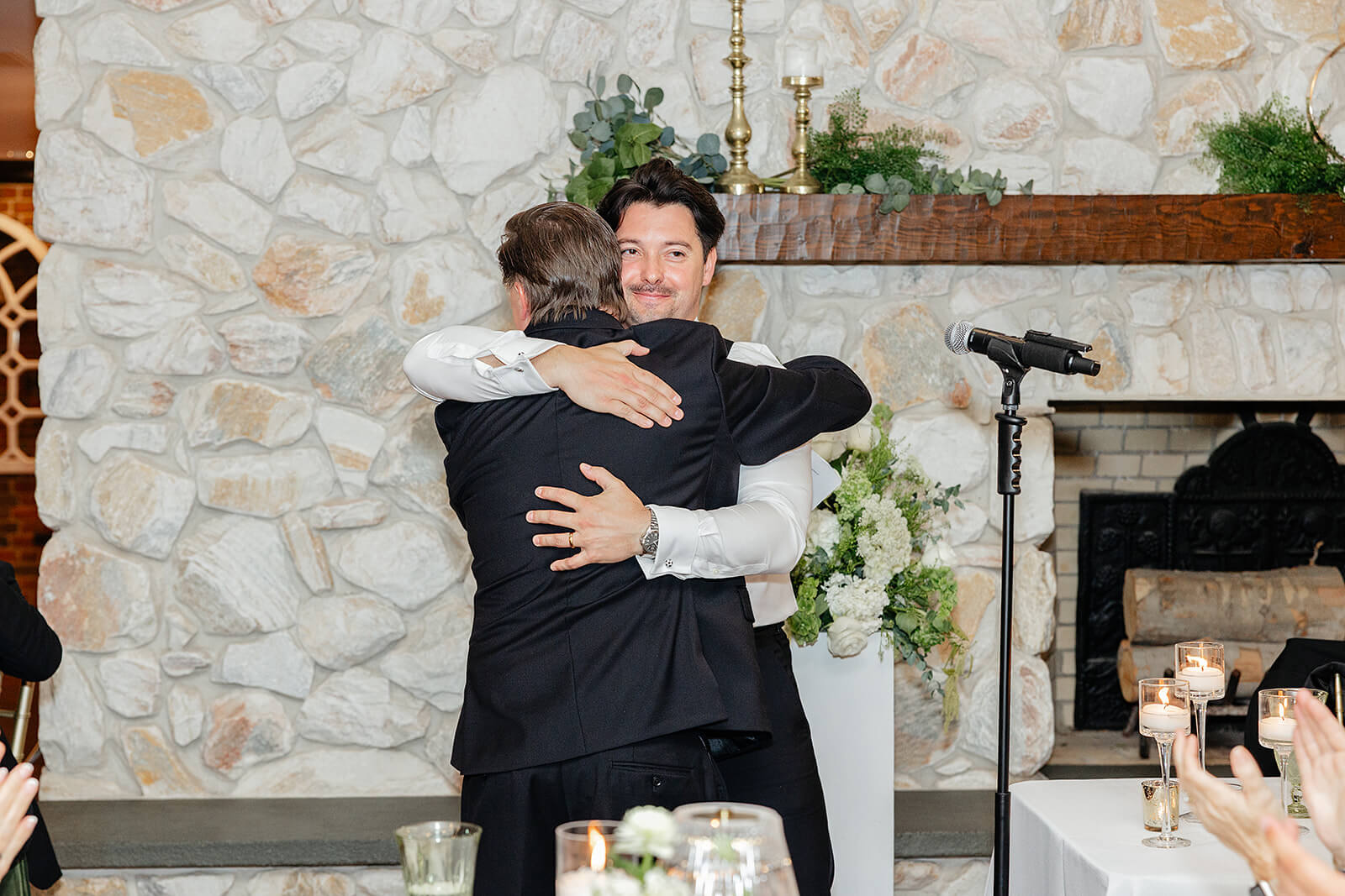 Estate at River Run Summer Wedding Photography 34 groom hugging a friend after a speech