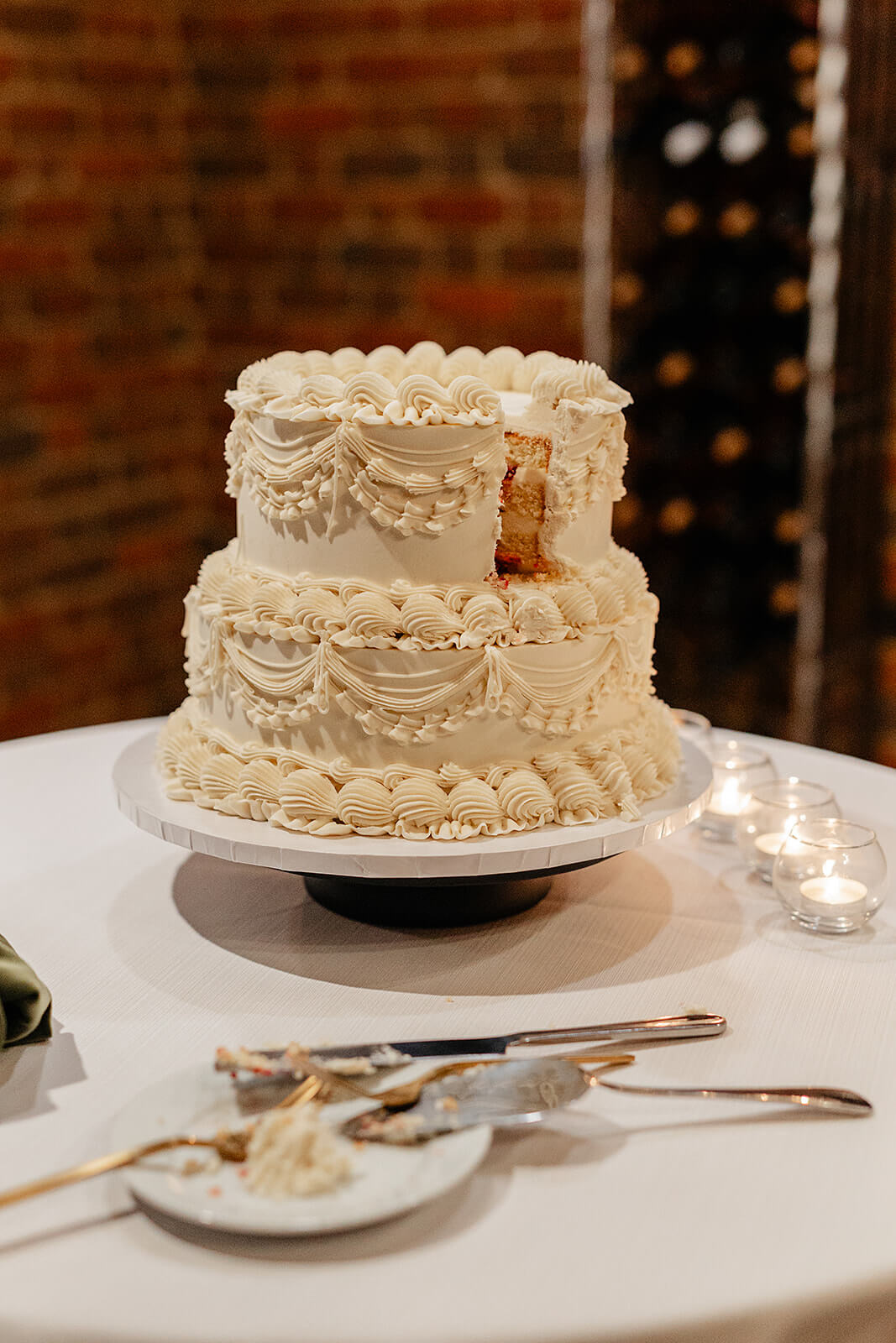 Estate at River Run Summer Wedding Photography 37 detail photo of wedding cake with a slice taken out of it