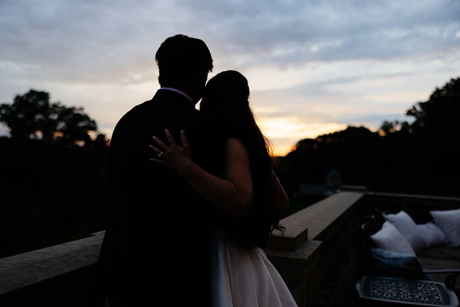 Estate at River Run Summer Wedding Photography 40 shadowy photo of bride and groom hugging each other with the sun setting