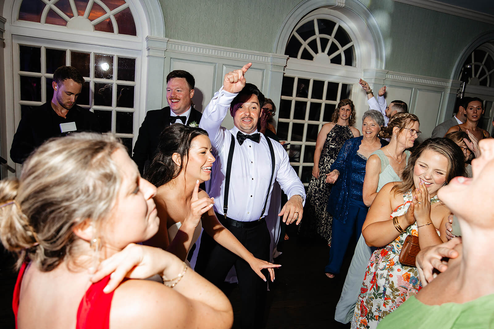 Estate at River Run Summer Wedding Photography 48 bride and groom dancing and jumping with their guests