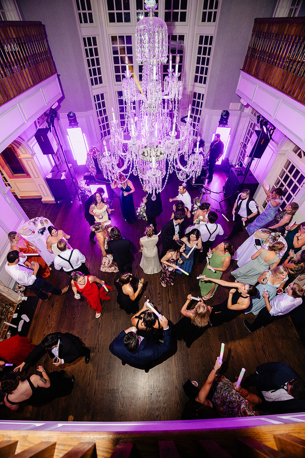 Estate at River Run Summer Wedding Photography 51 overhead shot of guests dancing a multicolor lit dance floor