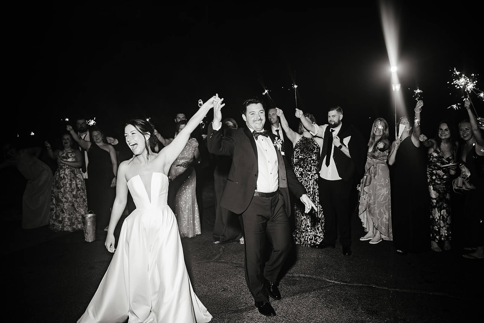 Estate at River Run Summer Wedding Photography 53 black and white photo of bride and groom leaving with their guests around them holding sparklers