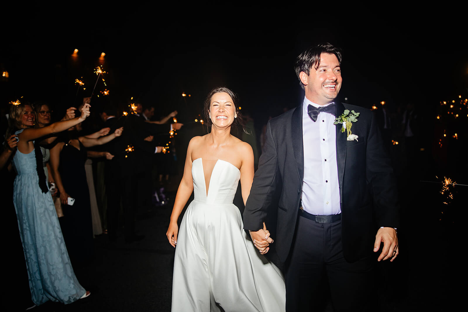 Estate at River Run Summer Wedding Photography 54 bride and groom holding hands and they walk out between their guests