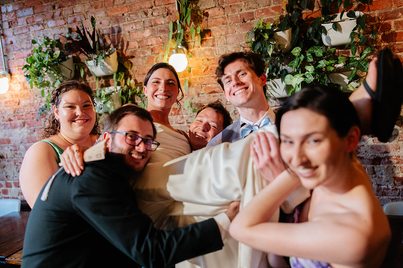 Laura Lee's Spring Wedding Photography 25 bride and groom with their friends who are holding the bride in the air