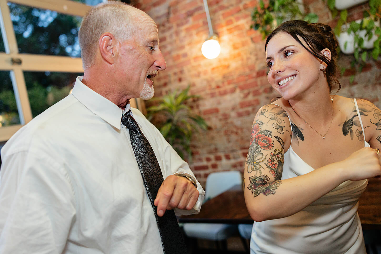 Laura Lee's Spring Wedding Photography 26 bride dancing next to guest as he talks to her