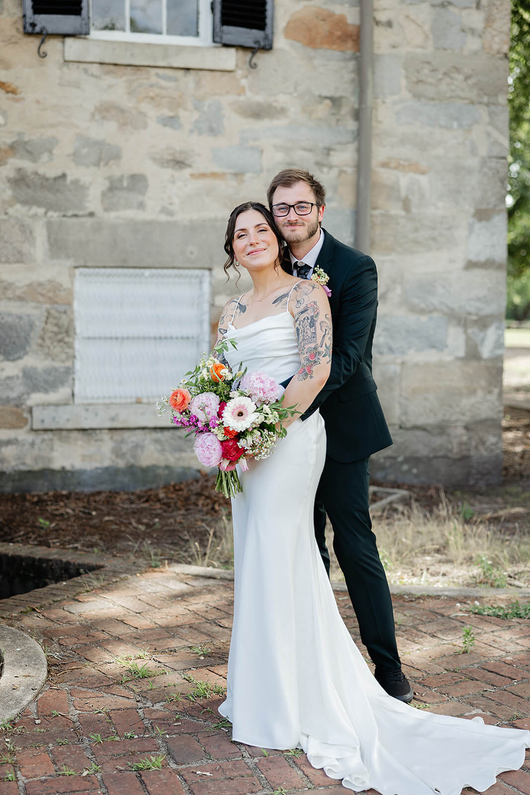 Laura Lee's Spring Wedding Photography 9 portrait of bride and groom, he is hugging the bride from behind