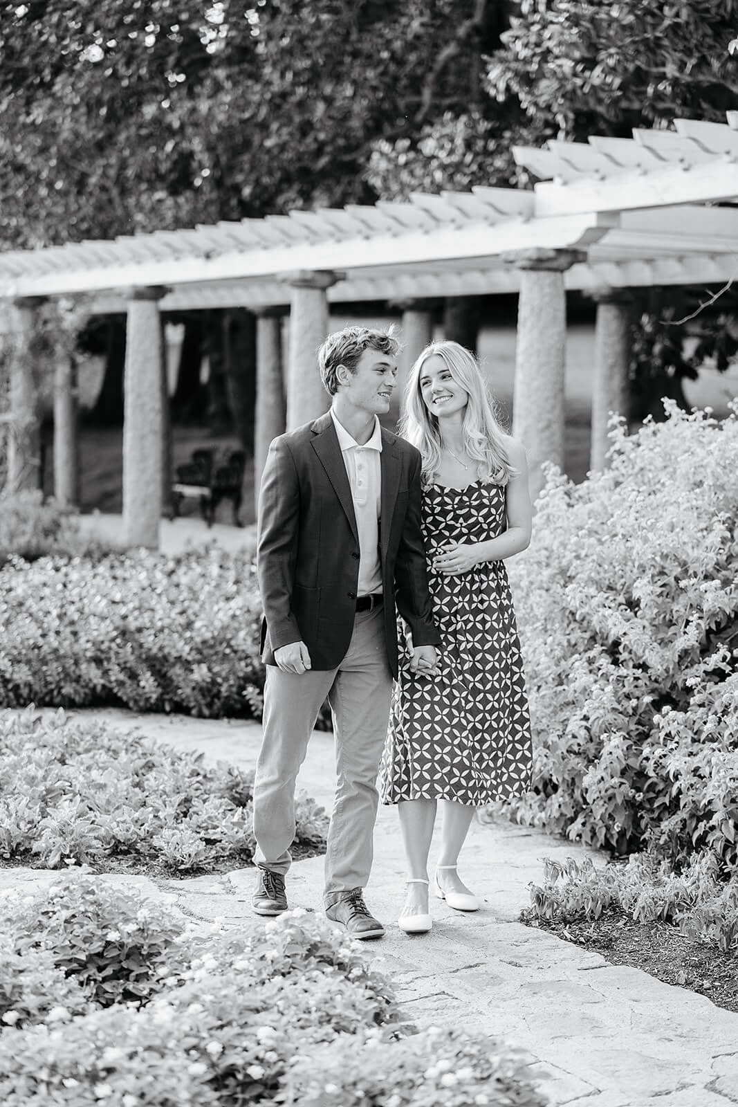 Maymont Summer Engagement Photography 6 black and white photo of couple holding hands and walking through garden