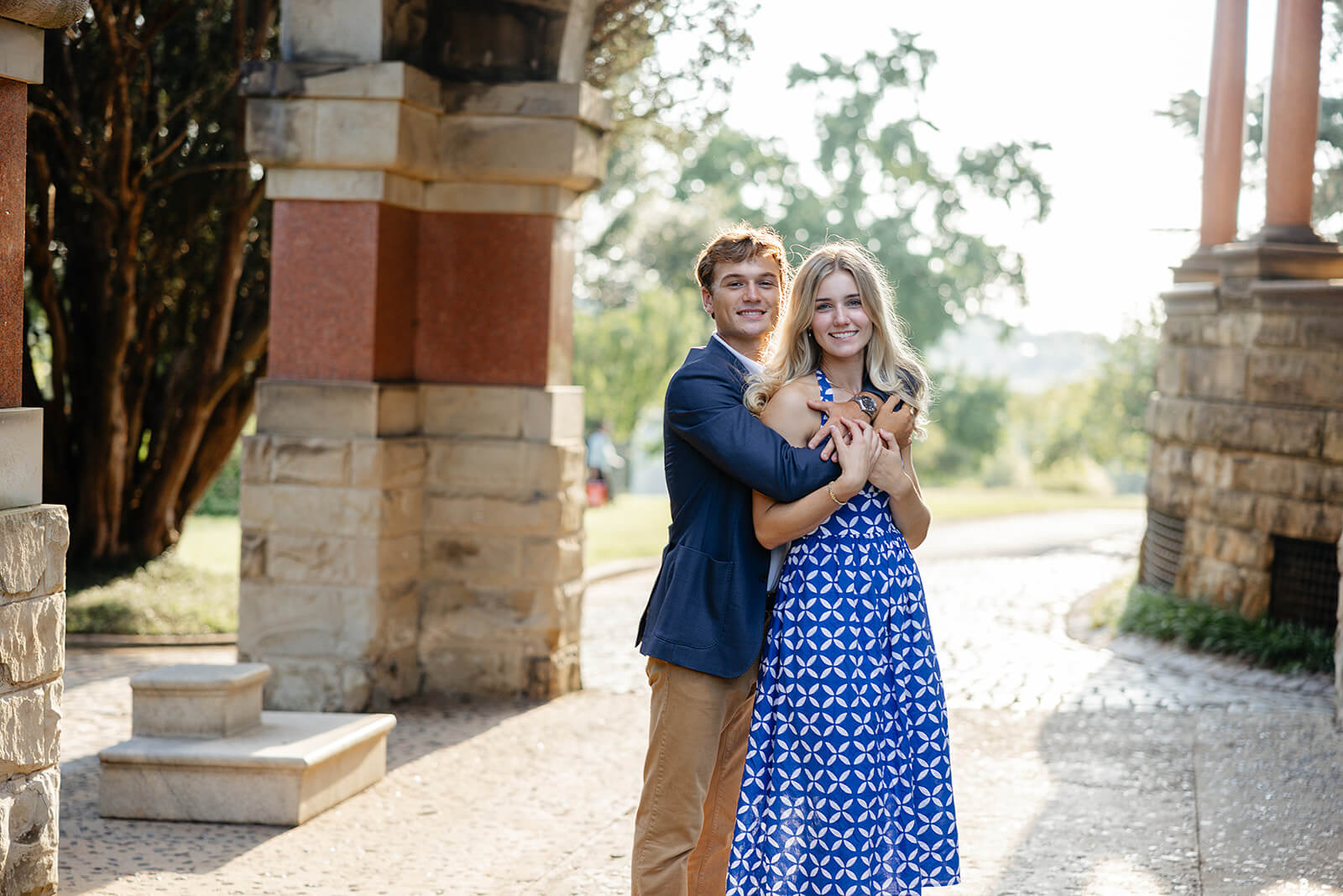 Maymont Summer Engagement Photography 10 man hugging fiance from behind as they stand under historical house entryway
