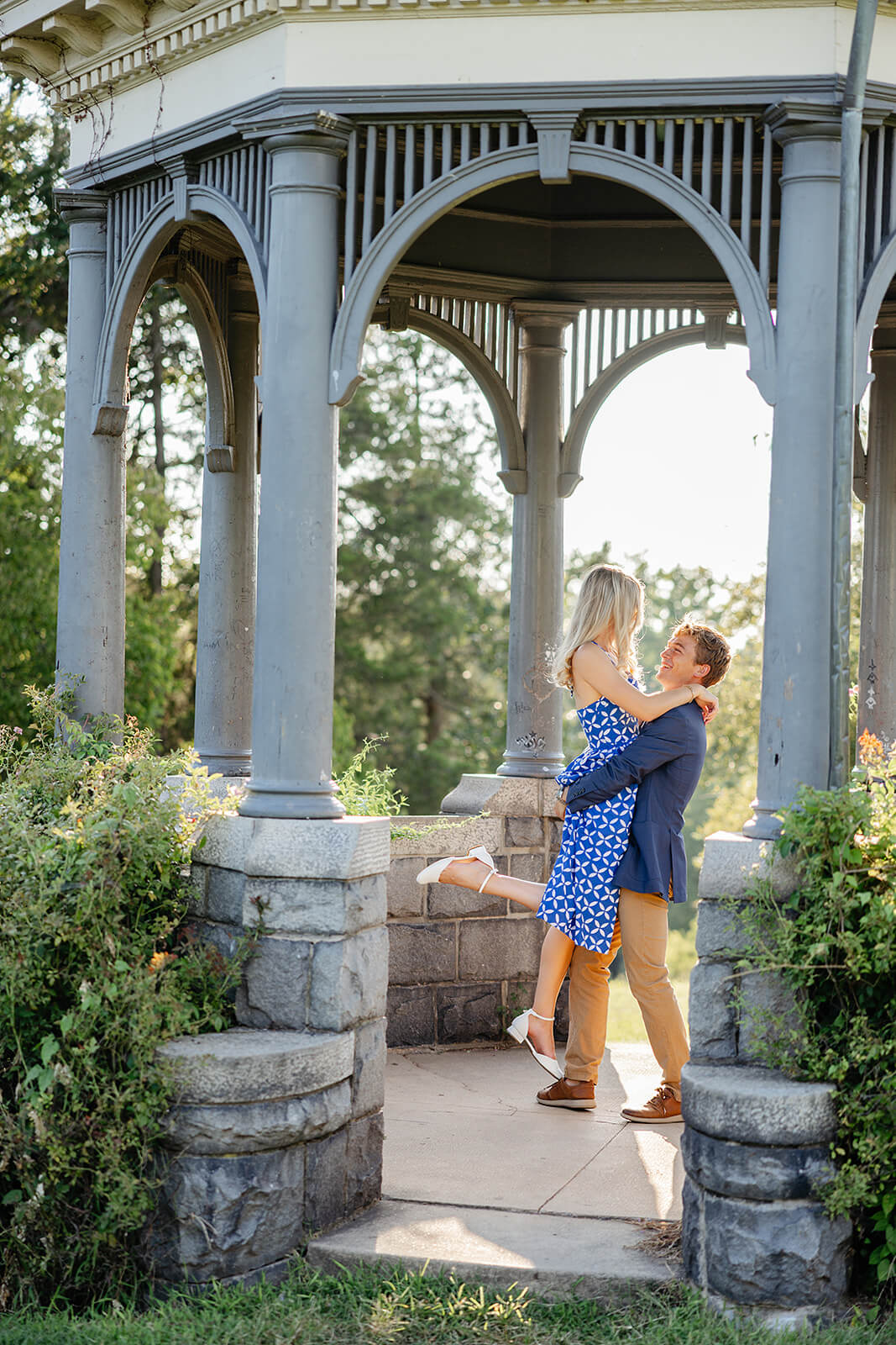 Maymont Summer Engagement Photography 13 Man holding his fiance up in a gazebo