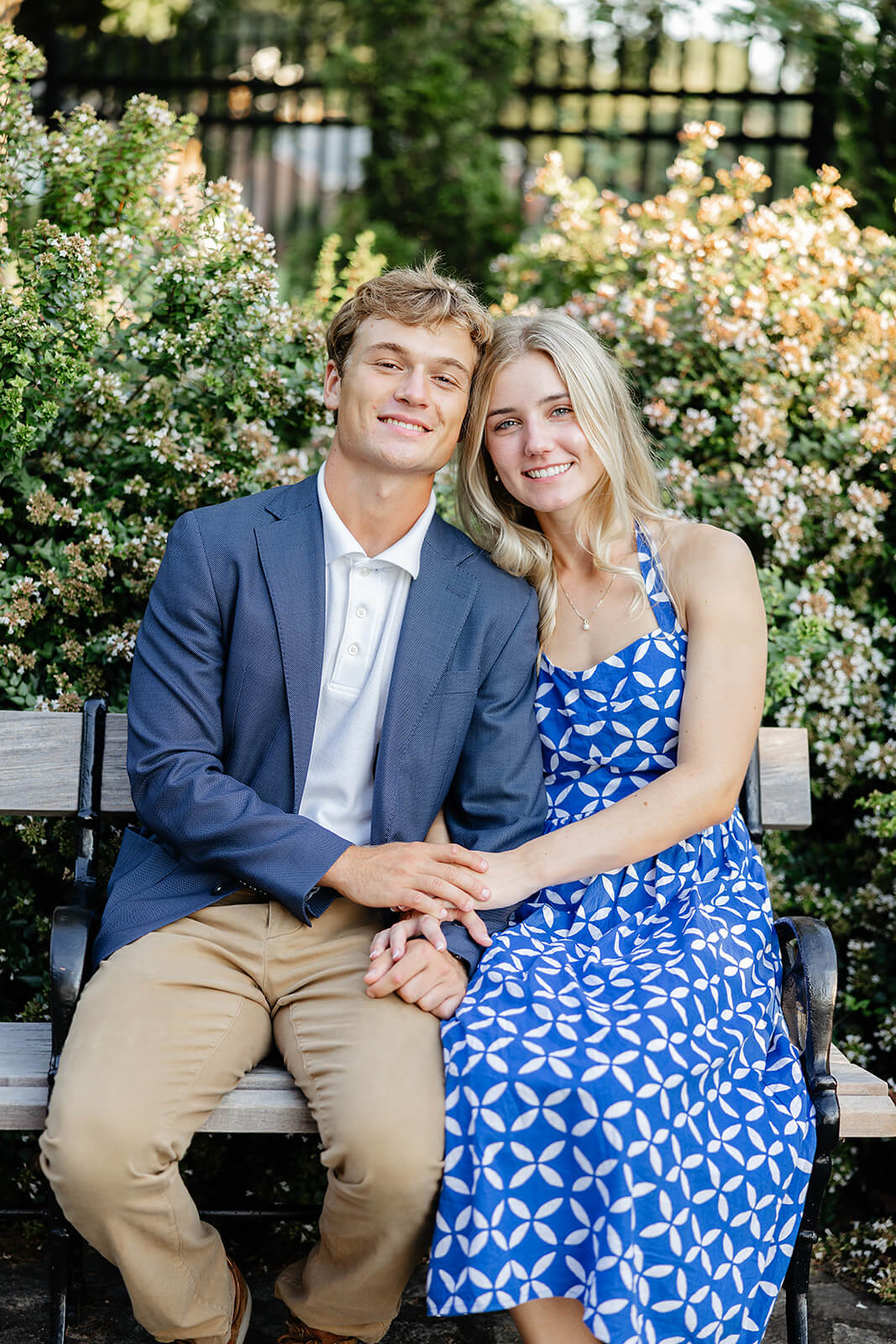 Maymont Summer Engagement Photography 20 portrait of couple holding hands and sitting on a wooden bench