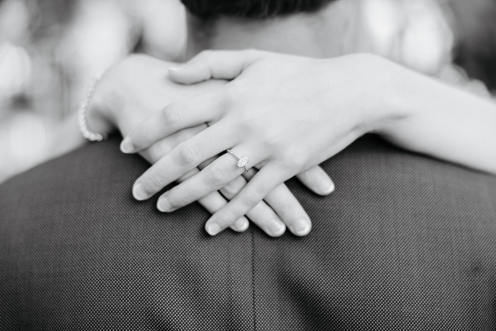 Maymont Summer Engagement Photography 21 black and white photo of woman's engagement ring on her hand laid across her fiance's back