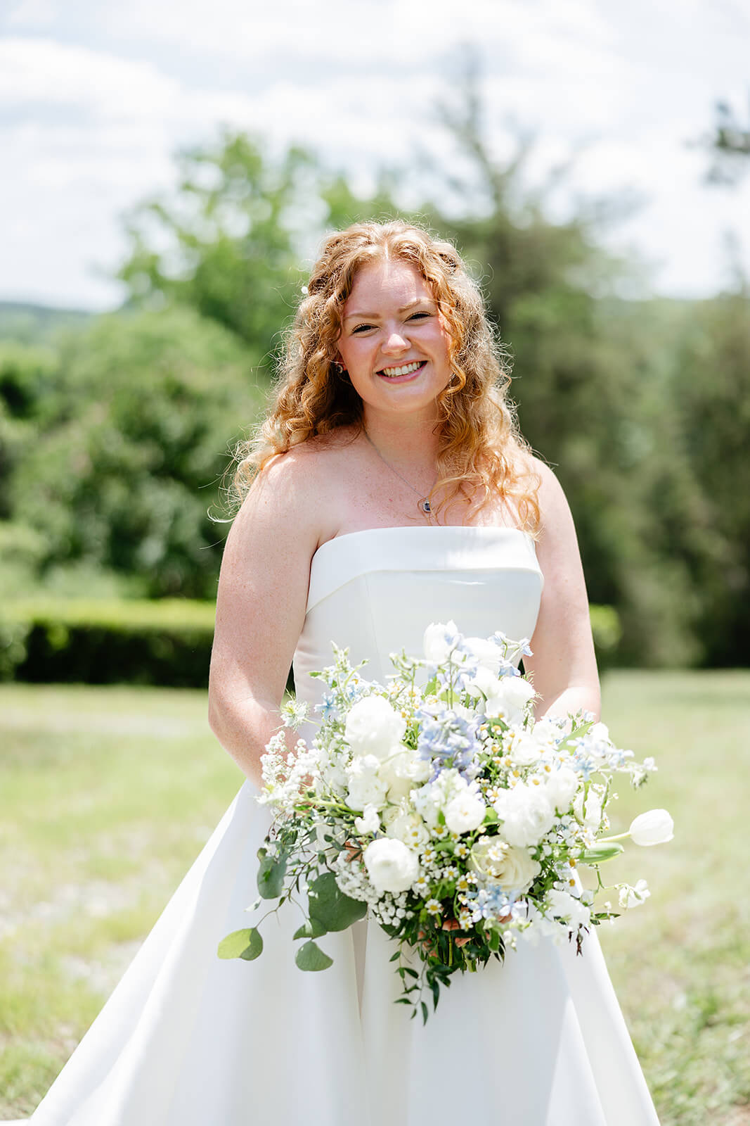 Rassawek Vineyard Spring Wedding Photography 11 portrait of bride outside in her dress with her bouquet