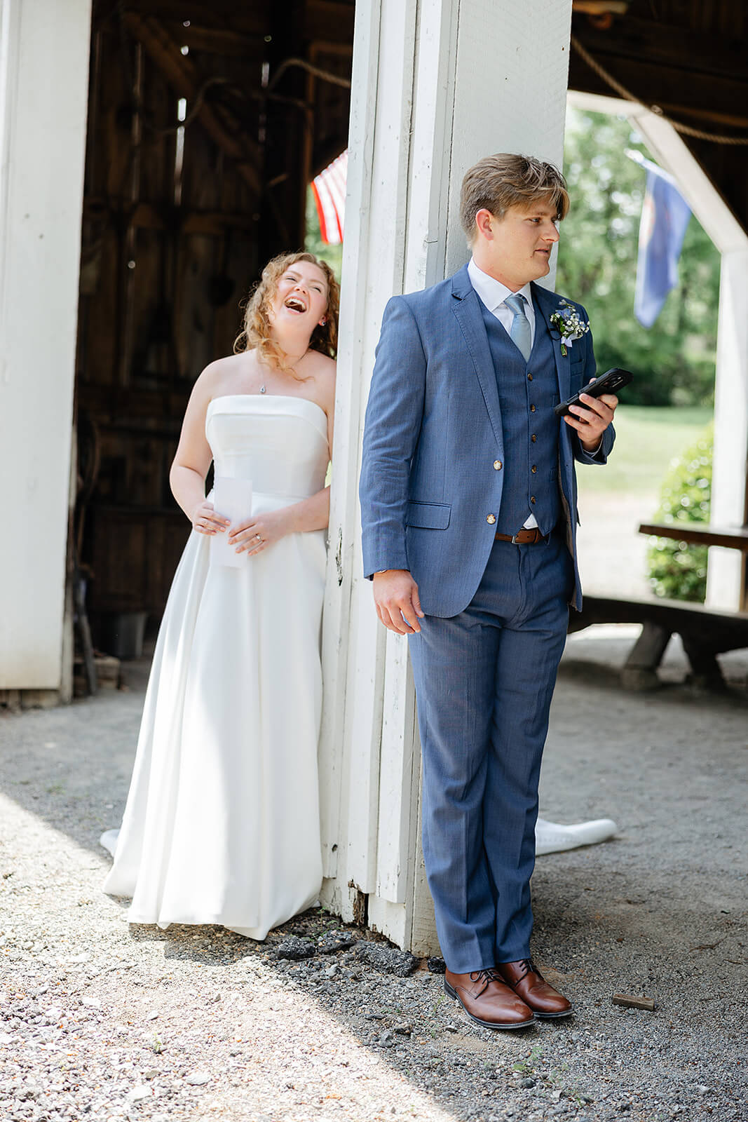 Rassawek Vineyard Spring Wedding Photography 12 bride and groom sharing private vows standing on opposite sides of a large column, bride is laughing with joy