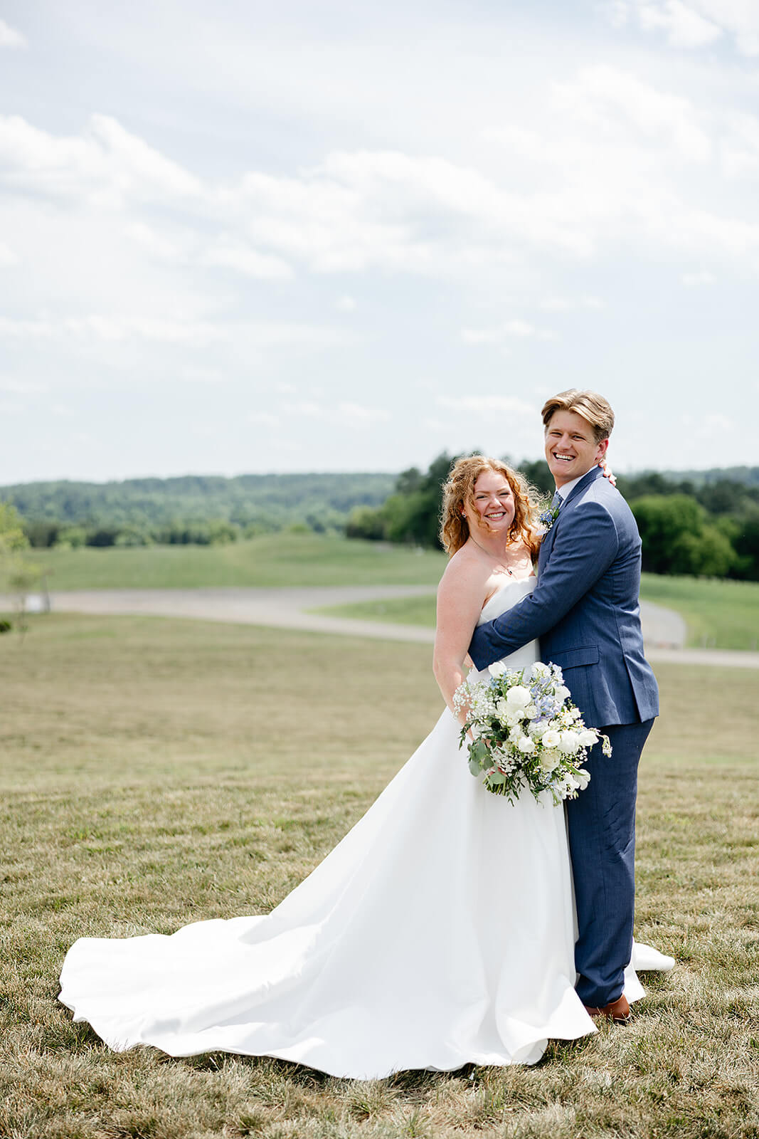 Rassawek Vineyard Spring Wedding Photography 21 portrait of bride and groom outside on a lawn hugging each other