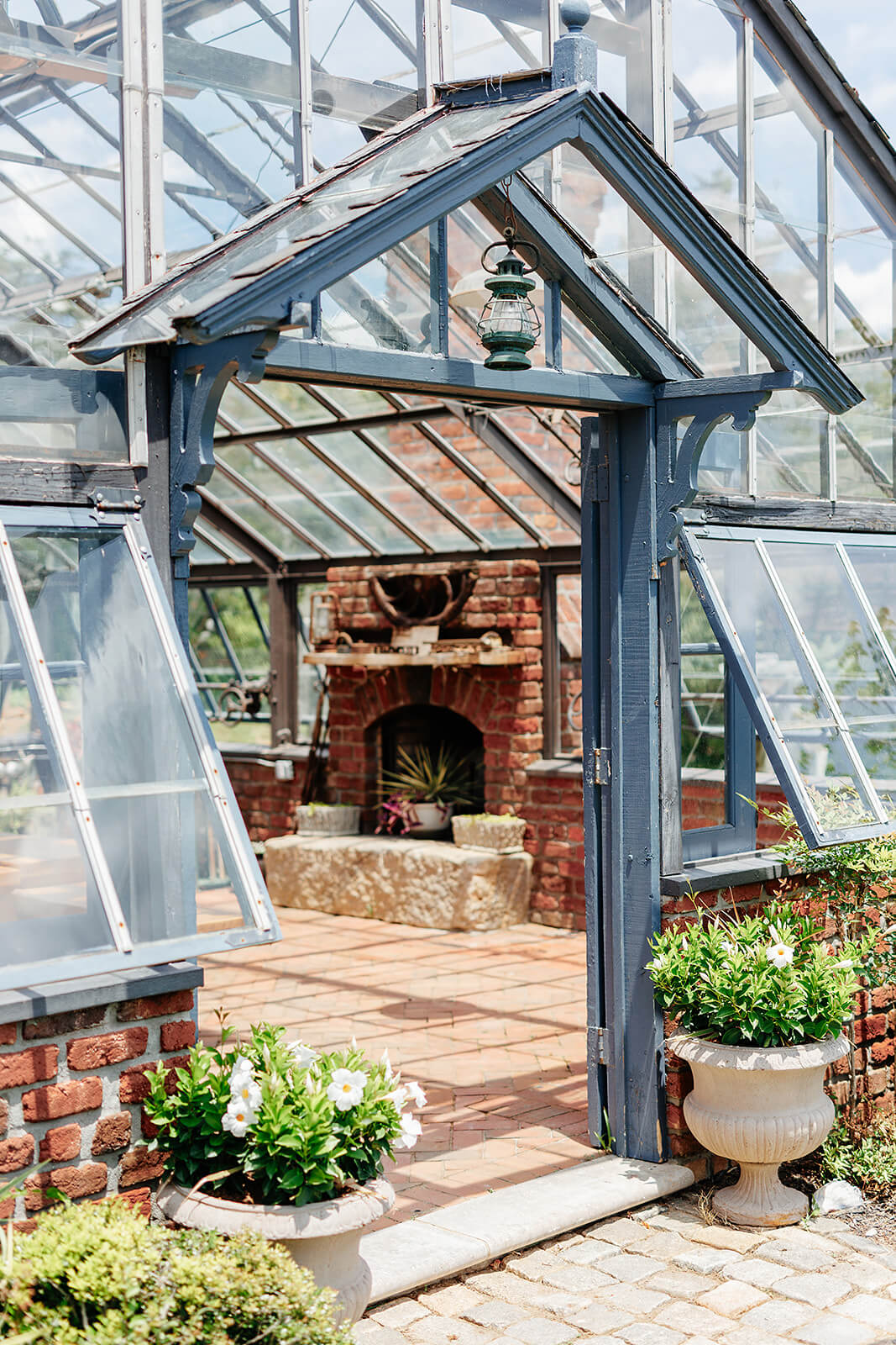Rassawek Vineyard Spring Wedding Photography 3 detail photo of greenhouse with fireplace and glass window walls and ceiling
