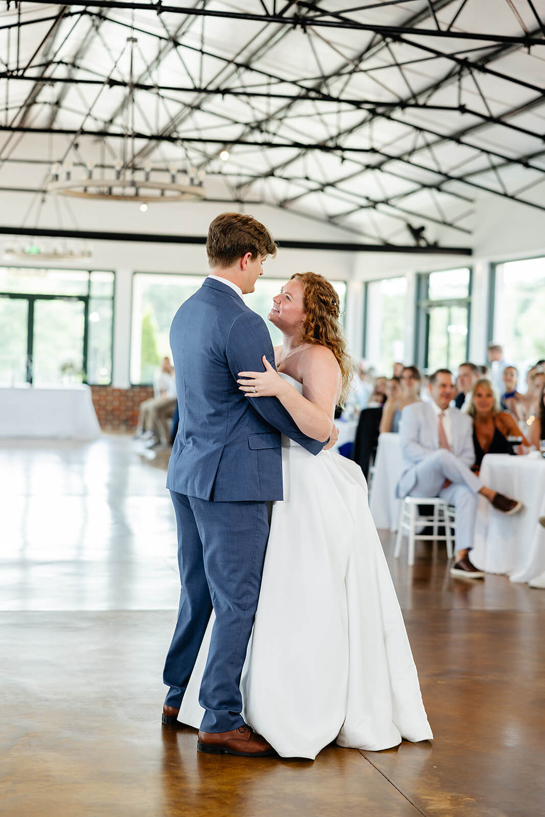 Rassawek Vineyard Spring Wedding Photography 35 bride and groom sharing the first dance together as guests sit and watch