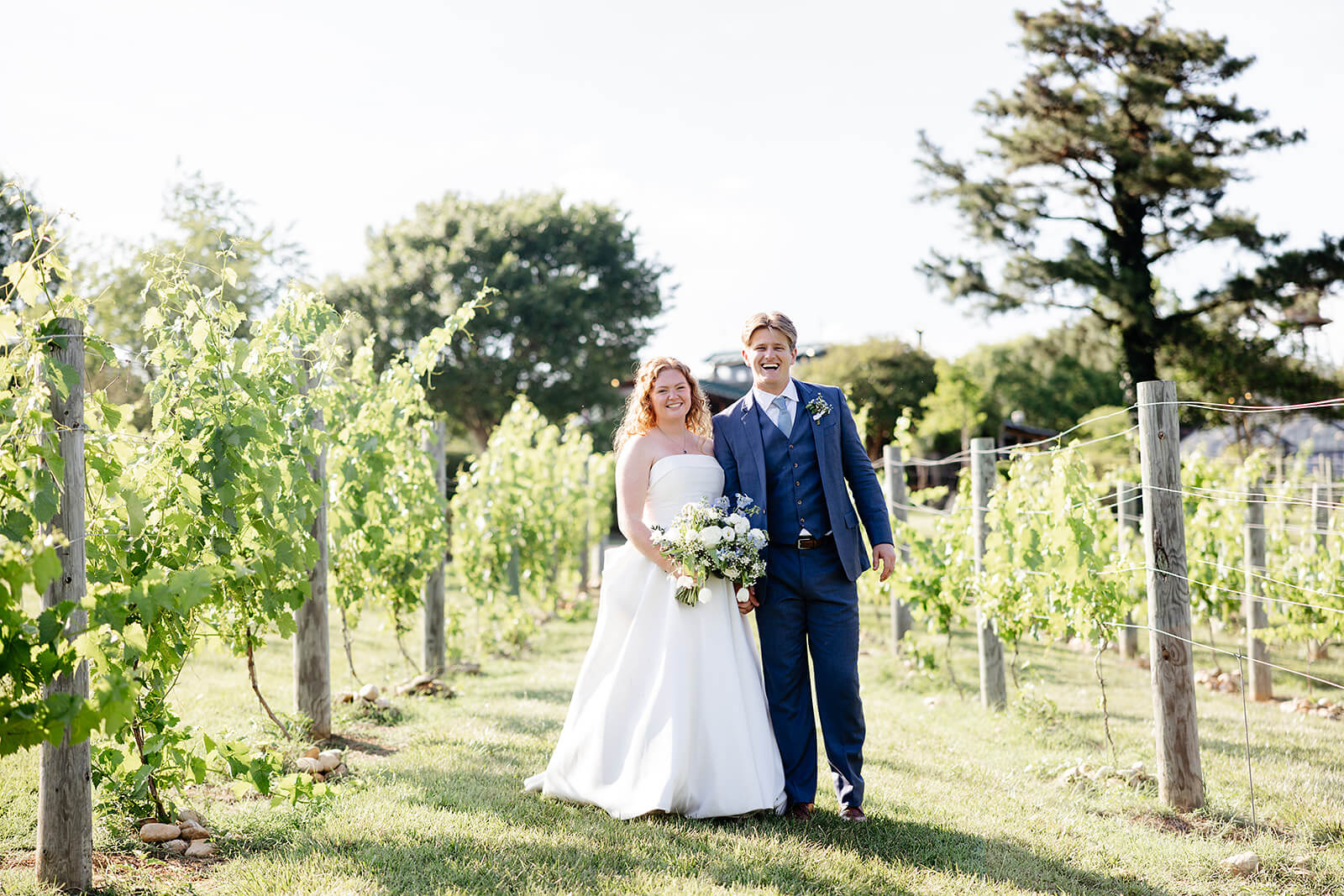 Rassawek Vineyard Spring Wedding Photography 24 bride and groom standing side by side in between rows of vines