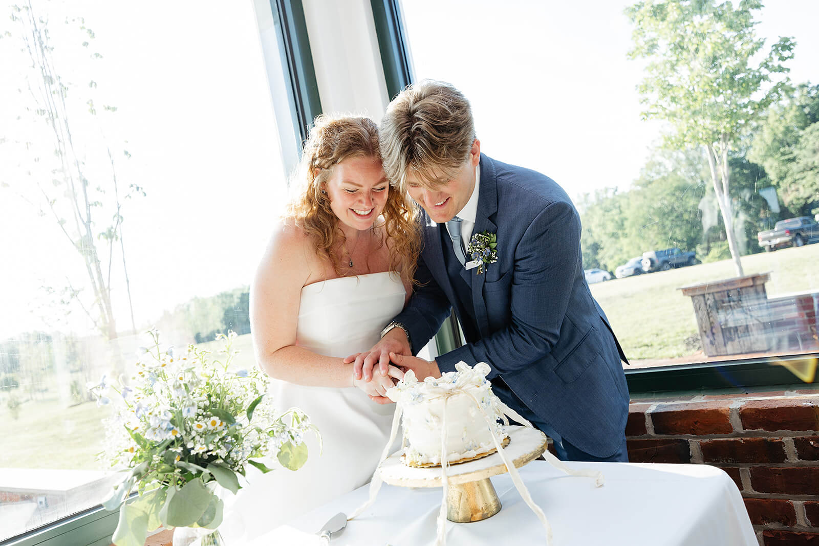 Rassawek Vineyard Spring Wedding Photography 39 bride and groom cutting their cake together