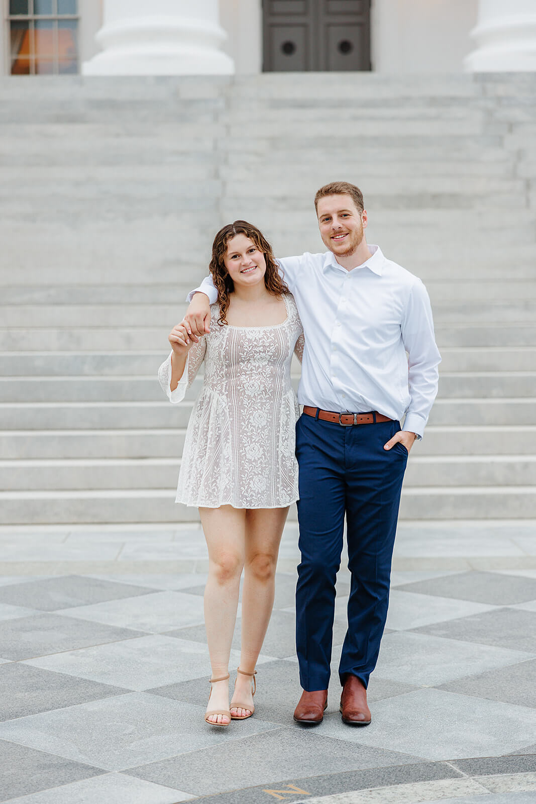 Virginia Capital Fall Engagement Photography 11 couple facing the camera standing side by side, his arm is around her shoulder and her arm is around his waist