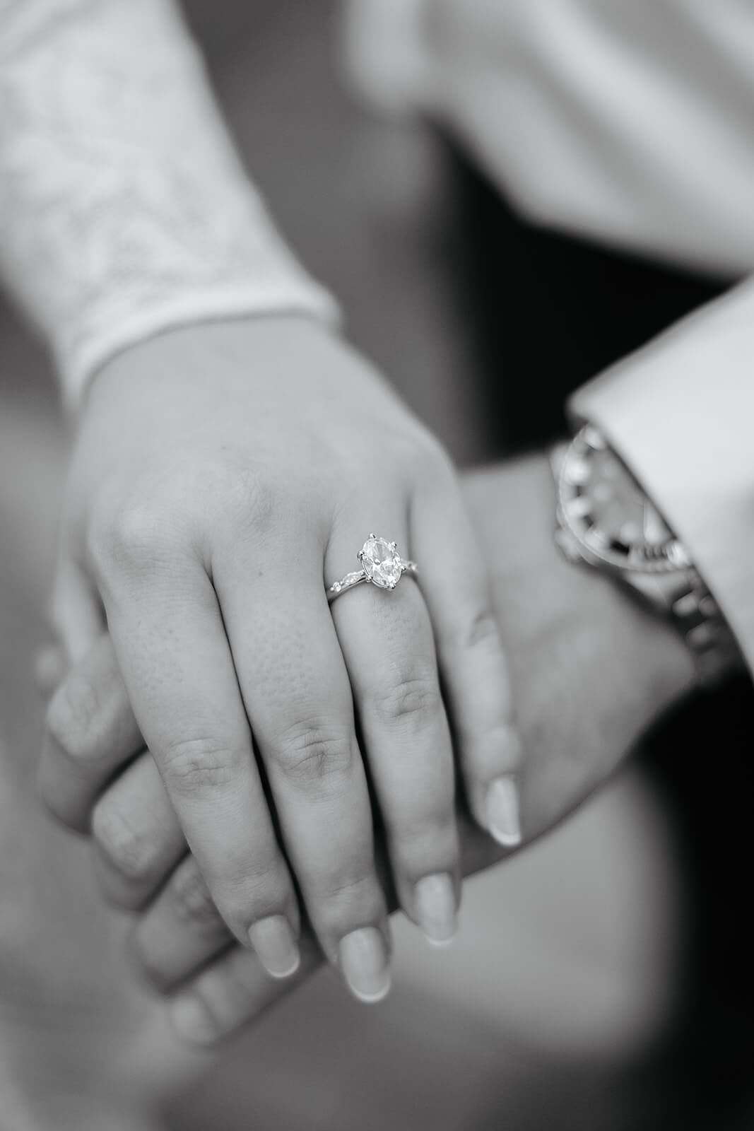 Virginia Capital Fall Engagement Photography 20 black and white photo of couple's hands on top of each other, she is wearing a engagement ring with a large diamond stone